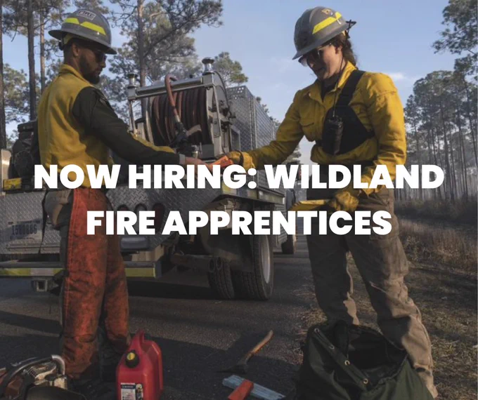 Now hiring wildland fire apprentices. Two wildland firefighters stand behind an engine prepping saw gear