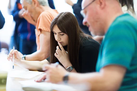 A woman holding a pen