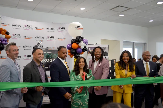 Several public officials, including DHCD Secretary Jake Day, pose for a photo before the official ribbon cutting of the Media Rhythm Institute in Baltimore on May 17, 2023.
