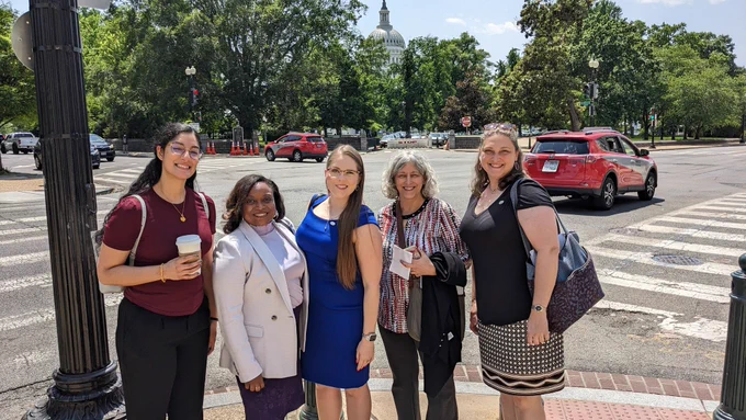 Sarina Neote, Shantá Hinton, Marissa Locke-Rottinghaus, Jill Johnson, and Karen Lewis pose for a photo across the street from the U.S. Capitol during ASBMB's Hill Day on May 17. 