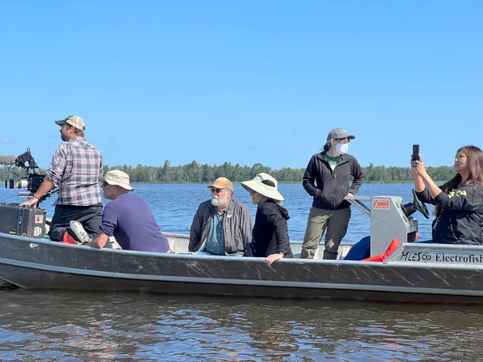 The film crew from Clouds North Films and partners from the Bad River Band of Lake Superior Tribe of Chippewa Indians and the Mashkiiziibii Natural Resources Department sit in a boat looking out onto the Kakagon/Bad River Sloughs.