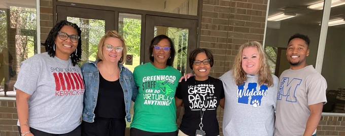Photo of Carla Cosby, Marcus Howard, Jacqueline Johnson, Kristie Joyce, Nicole Joyner, and Amy Medley smiling. 