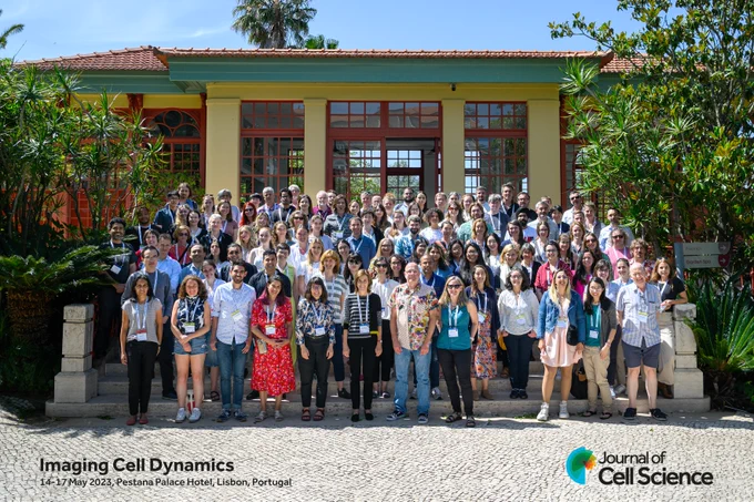 Participants from #celldyn2023 on steps outside a building.