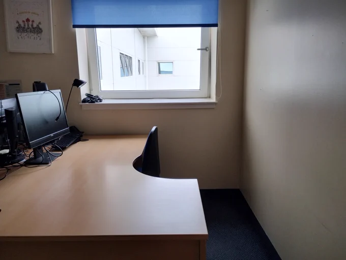 Empty office space with desk and window