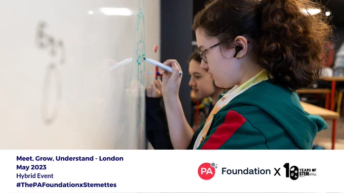 a young woman writing on a whiteboard