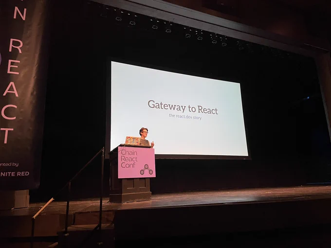 Rachel on stage behind the podium, giving a talk