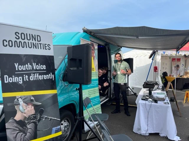 Picture of three of the sound communities team behind their stand