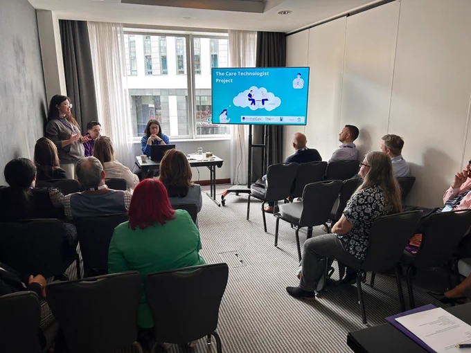 The team presenting to a group of conference attendees in a breakout session. 