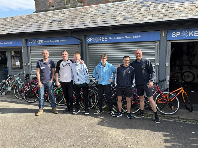 Students from Headlands School stand in front of their newly donated bicycles 