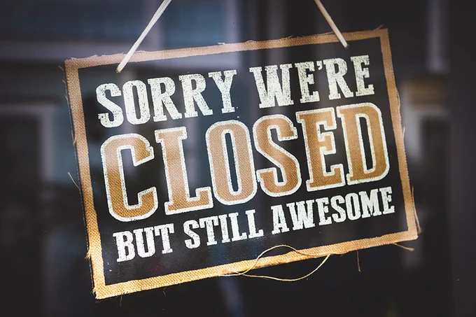 a sign on a glass door with the words "sorry we're closed but still awesome."