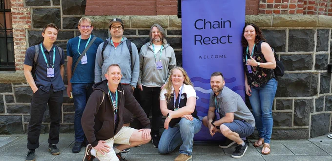 Posing in front of the Armory, a group of old and new friends made at Chain React 2023