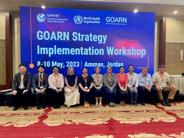 Members of the Global Outbreak Alert and Response Network pose for a photo in front of a sign that says GOARN Strategy Implementation Workshop 8-10 May 2023, Amman, Jordan

Photo shows a group of men and women smiling at the camera 