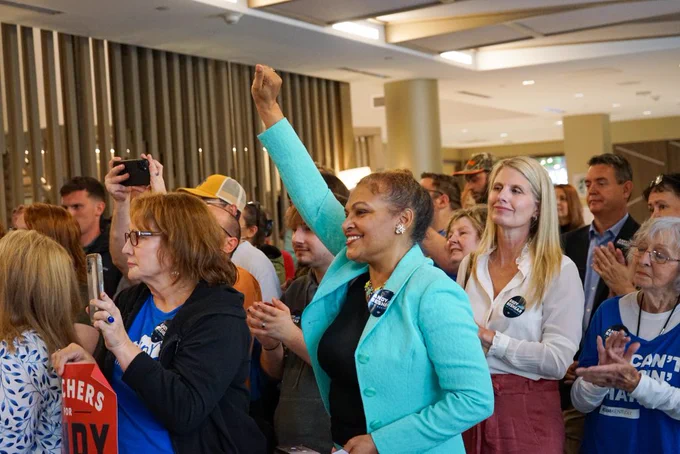 An excited crowd cheers for Andy Beshear