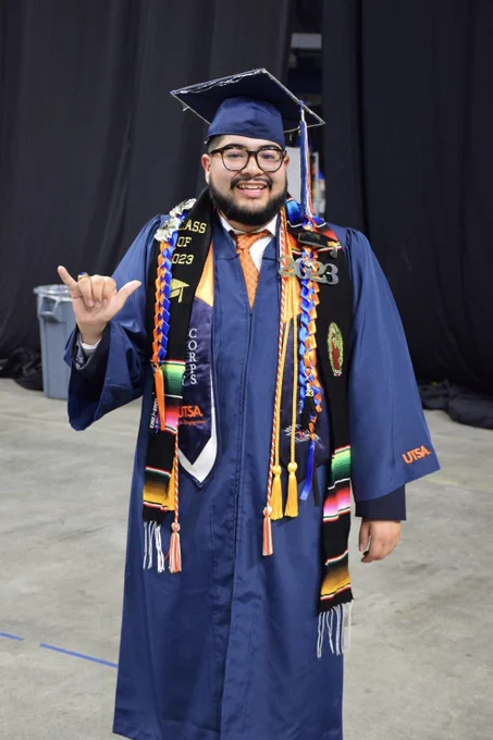 A graduate poses for a photo.