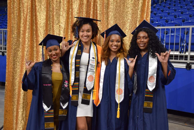 Graduates pose for a photo backstage.