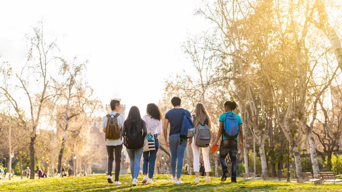 College students walking on a college campus.