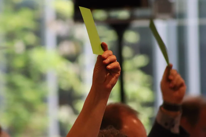 Hands with green cards