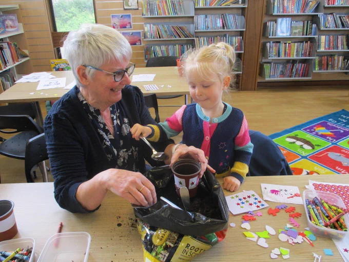 Olivia and her Gran are planting sunflower seeds