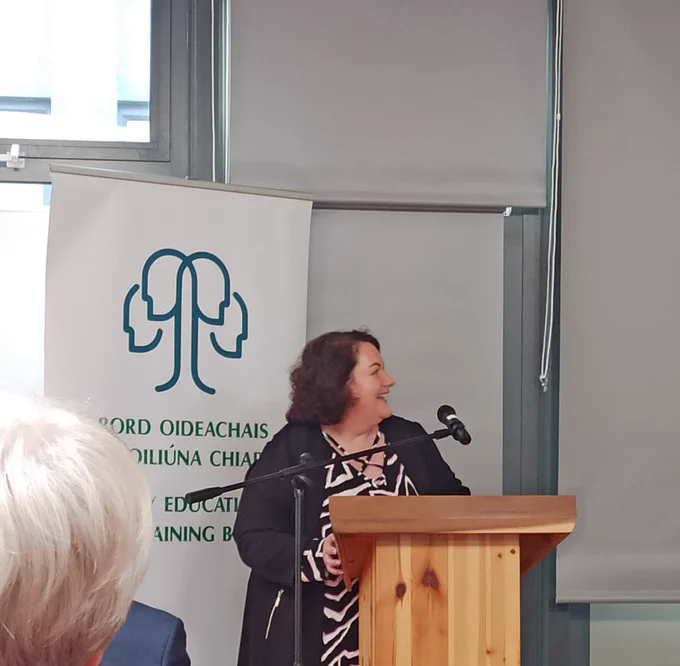 Image of Jean Reale standing in front of a Kerry ETB banner, smiling as she launches her PHD project 