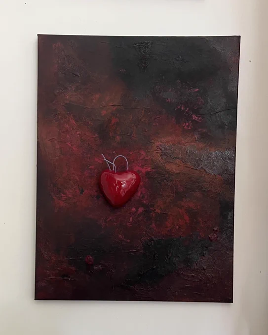 Artwork by Corinne Thompson. Mixed media on canvas showing a glossy bright red heart on painted background with textures in dark red and black.