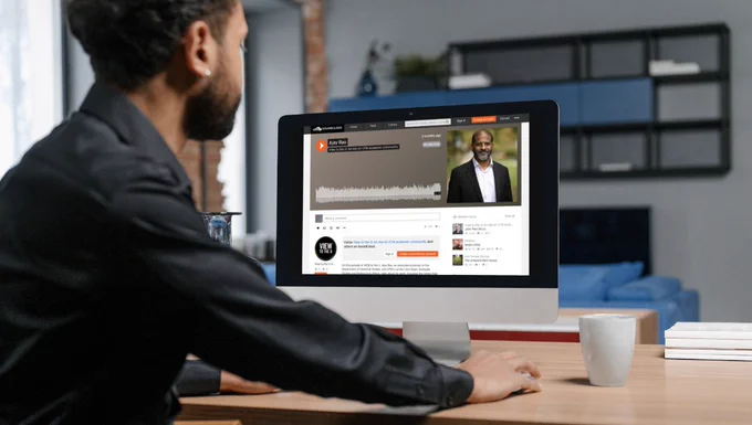 Person on a laptop with View to the U podcast open on screen.