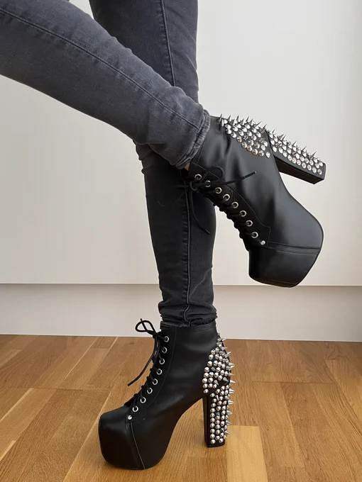 Beautiful studded black leather platforms with laces worn by Pind in her gray jeans.