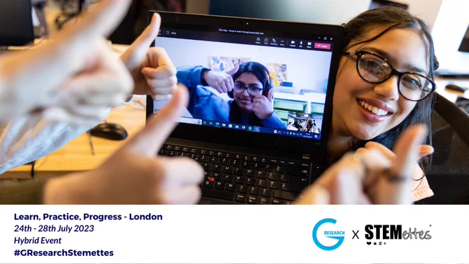 A young girl holding up a laptop with an online participant posing for a picture