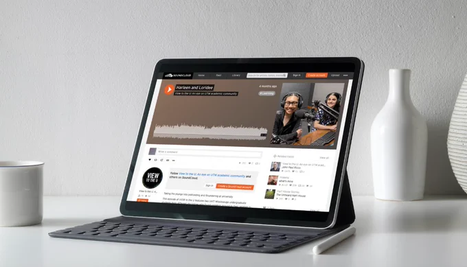 Person on a laptop with View to the U podcast open on screen.