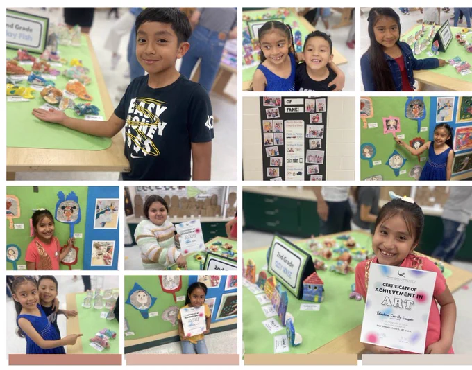 Second grade students who are showing off their art, and their certificate of achievement in art