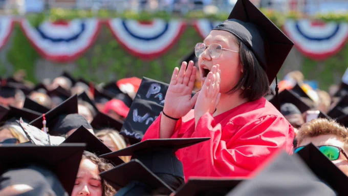 Boston, MA - May 21: A graduating Boston University student calls out during David Zaslav's commencement speech.