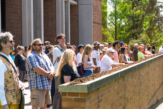 people visiting Leon's altar