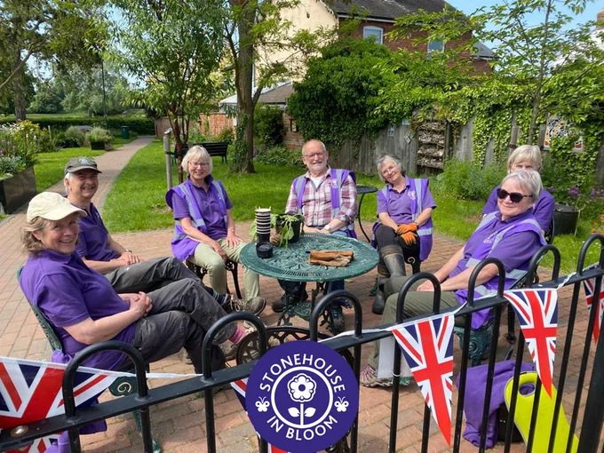 SIB team members sat around a table in The Old Chapel Garden, awating their cups of tea!