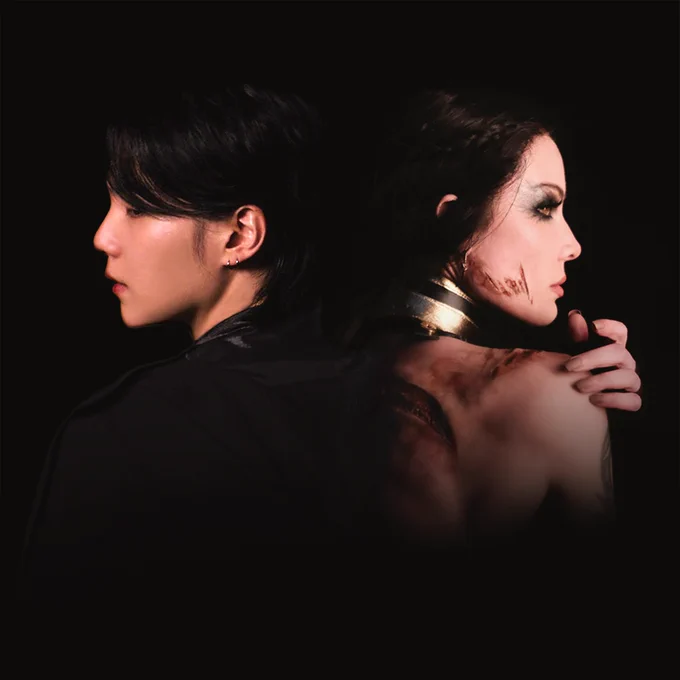 An image of artist Halsey & SUGA from BTS standing back to back in an ominous dark void. Halsey has wounds from an apparent battle and SUGA is adorned in all black.