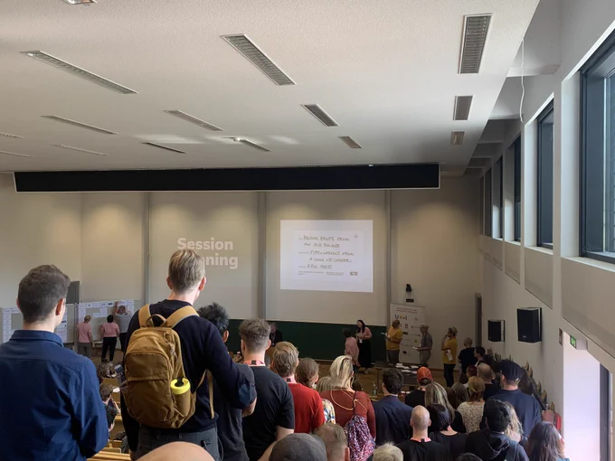 People queuing to pitch their ideas in front of a crowd