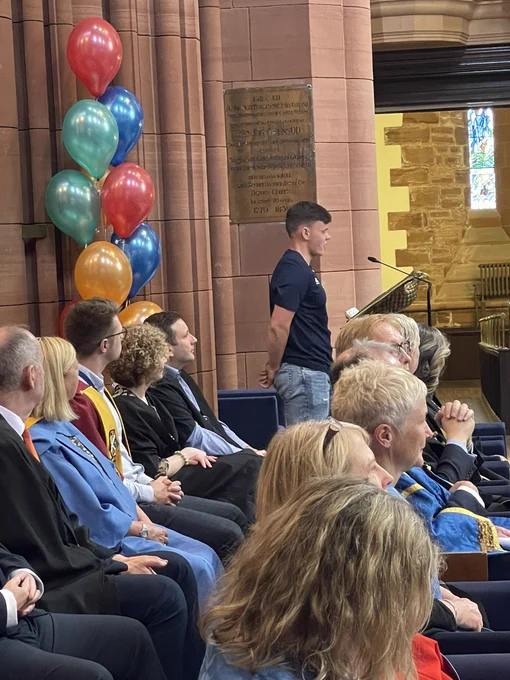 A boy giving a speech in the Barony Hall