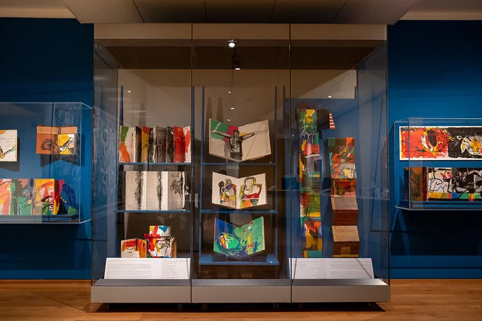 A photograph of vibrant works by Dia al-Azzawi on display in the Ashmolean Museum