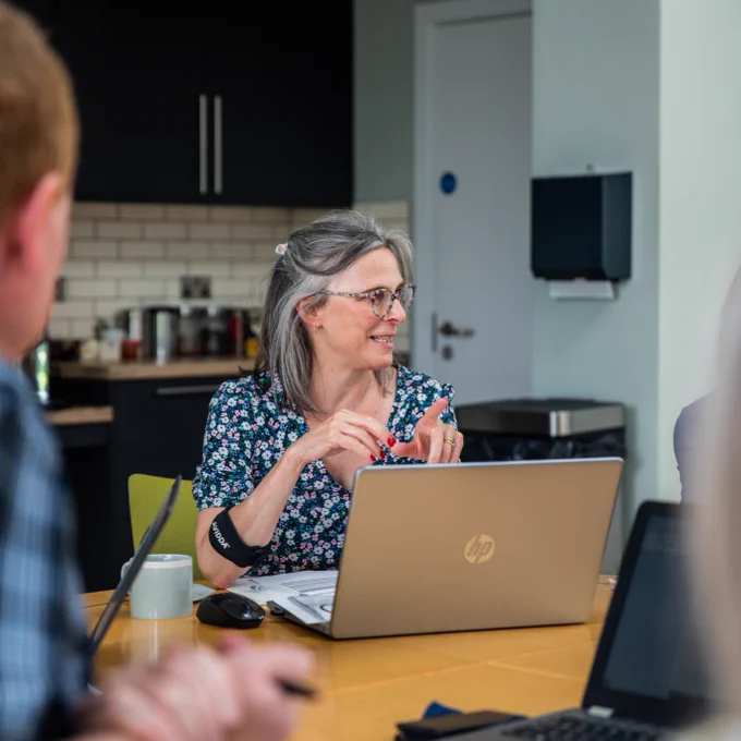 Photo of a female staff member at a meeting at Barnwood Trust