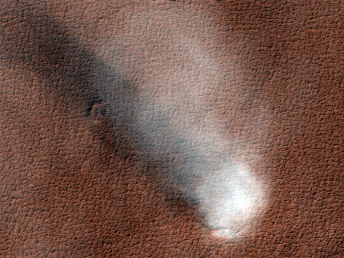 Enhanced color image shows a large dust devil with a column that extends high into the sky and casts a shadow on the terrain. Credit: NASA/JPL-Caltech/UArizona