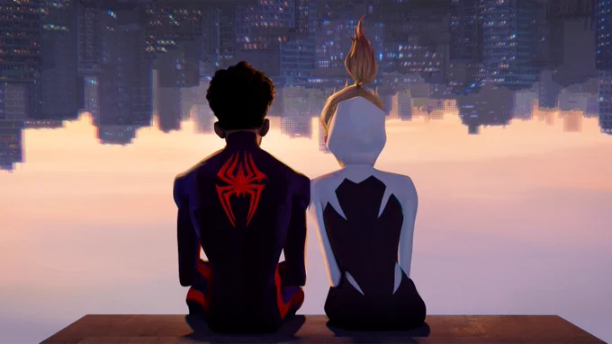 Still from Spider-Man: Across the Spider-Verse. Miles Morales and Gwen Stacy are sitting upside down, with the frame itself flipped upside down so that we see them right side-up and the cityscape in front of them upside down.