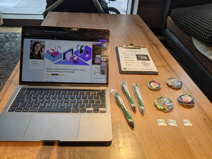Laptop to the left with the workshop open, a menu on the top, 3 pens, vonage stickers and womentechmakers stickers