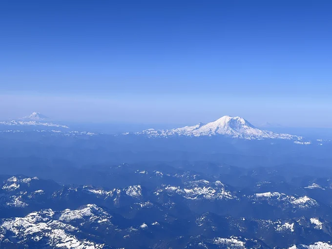 A photo of Mount Rainier, Mount Adam’s, and Mount St Helen’s from an airplane