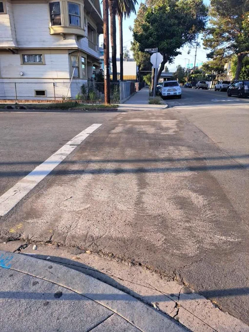Intersection at 22nd and Union showing asphalt scraped up after the crosswalk was removed. 