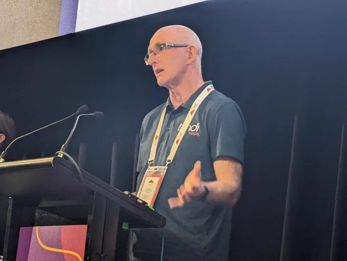 Tony Burrett from Bindimaps presenting at a lectern 