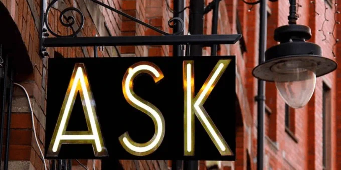 Lighted sign reading "ASK"