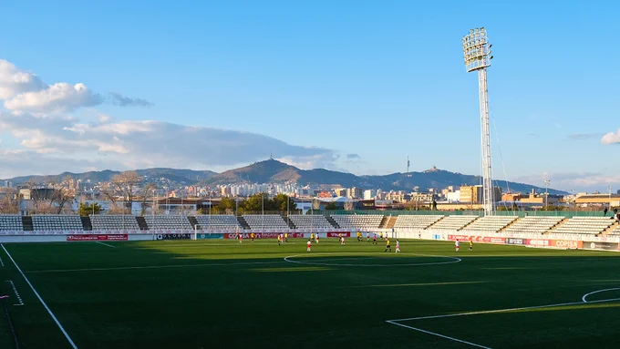 Mosslands play football in the distance in a stadium on a school sports tour organised by Rayburn Tours