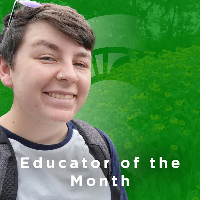 Riley pizza in a white and blue t-shirt, over a green background that reads "Educator of the Month."