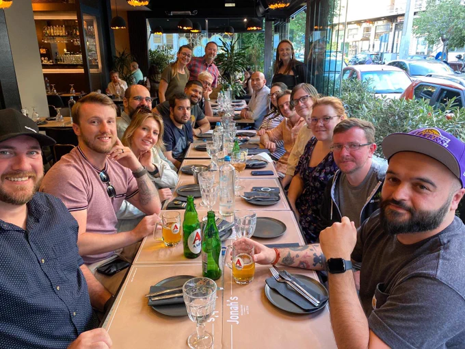 17 GoDaddy coworkers lining 2 sides of a long table