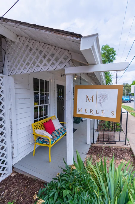 View of exterior signage and porch outside Merle's Cocktail bar in Wilkesboro. 