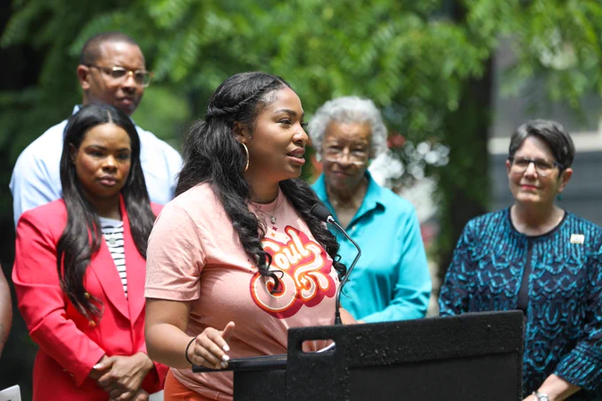 Martina Barksdale talks about Soulteenth Fest while standing at a lectern outside during a press conference