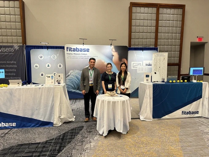 Photo of Team Fitabase in front of their booth.